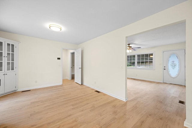 spare room with ceiling fan and light wood-type flooring