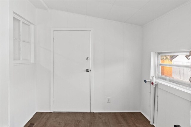 unfurnished room with dark wood-type flooring and lofted ceiling