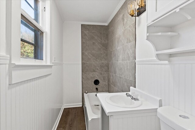 full bathroom featuring vanity, tiled shower / bath, toilet, ornamental molding, and wood-type flooring