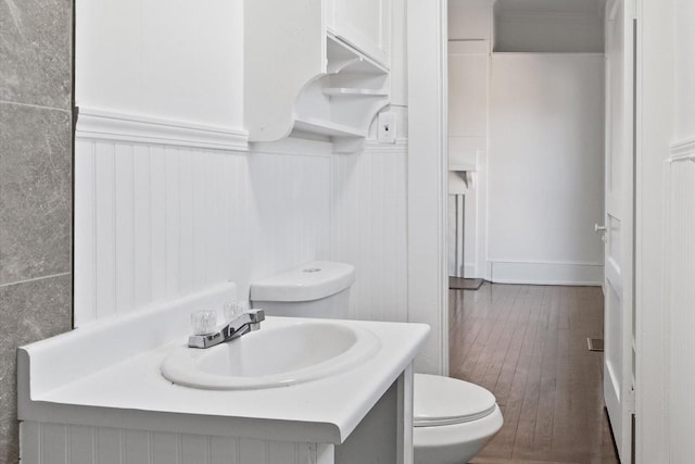 bathroom featuring vanity, hardwood / wood-style flooring, and toilet