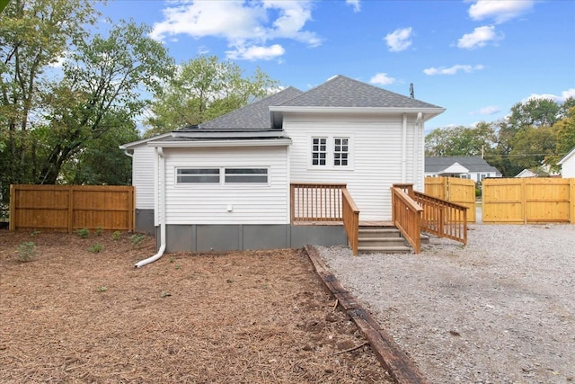 rear view of house with a wooden deck