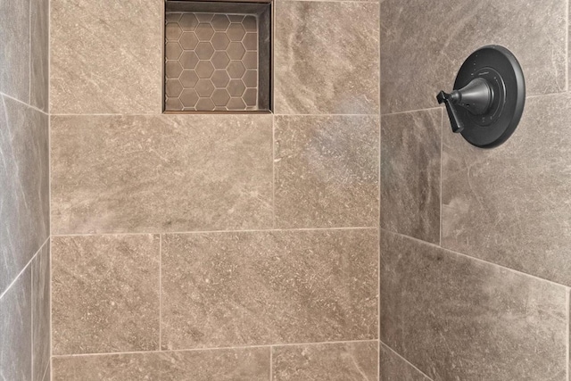 interior details with a tile shower