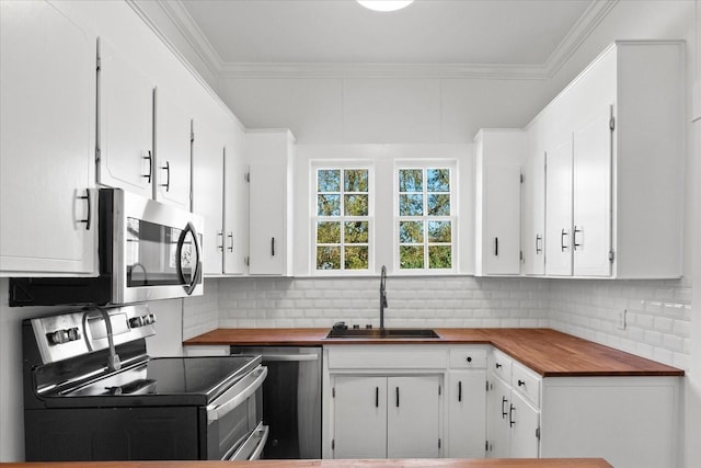 kitchen with white cabinets, backsplash, sink, and appliances with stainless steel finishes