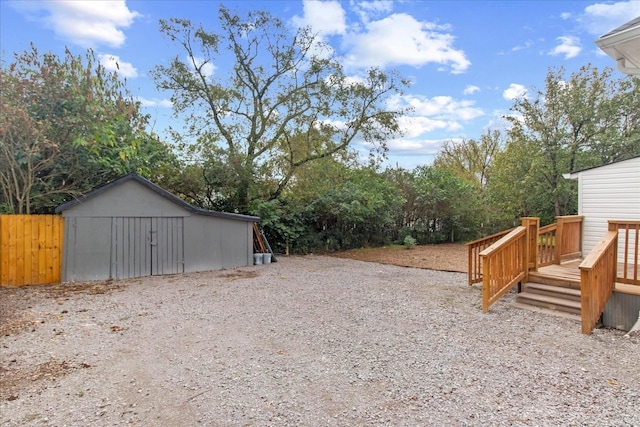 view of yard with a wooden deck and an outdoor structure