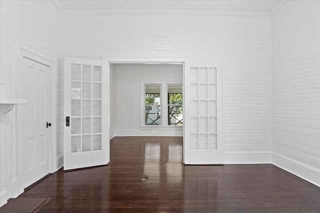 spare room featuring french doors, dark hardwood / wood-style flooring, and ornamental molding