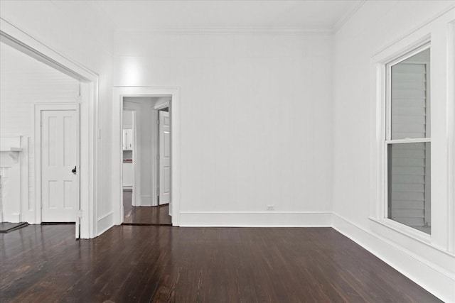 empty room featuring dark hardwood / wood-style floors and crown molding