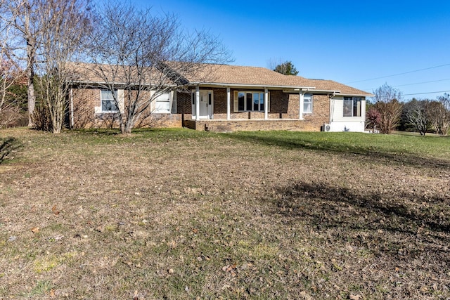 ranch-style home featuring a porch and a front lawn