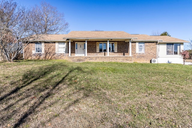 ranch-style home featuring a front yard and covered porch