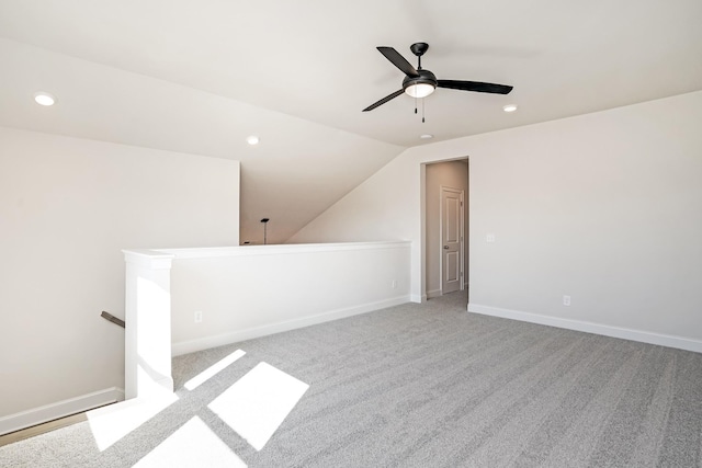 additional living space featuring light carpet, ceiling fan, and lofted ceiling