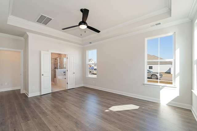 unfurnished bedroom with ornamental molding, a raised ceiling, ceiling fan, and dark wood-type flooring