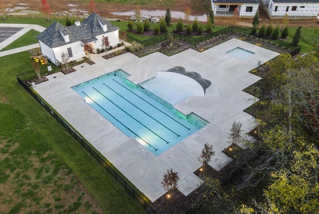 view of swimming pool with an outbuilding, a yard, and a patio