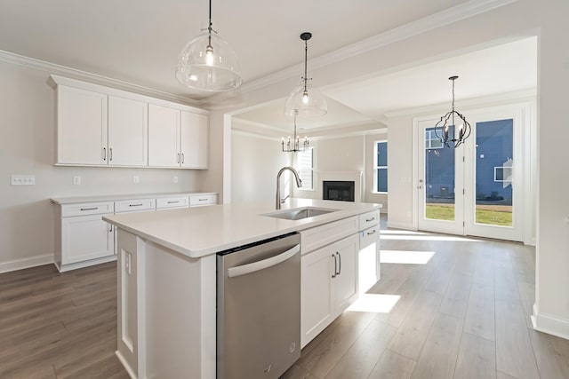 kitchen with dishwasher, pendant lighting, a center island with sink, and white cabinets