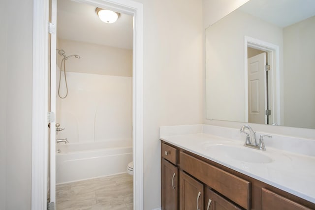 full bathroom featuring washtub / shower combination, vanity, and toilet