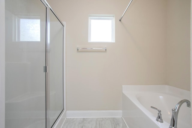 bathroom with separate shower and tub