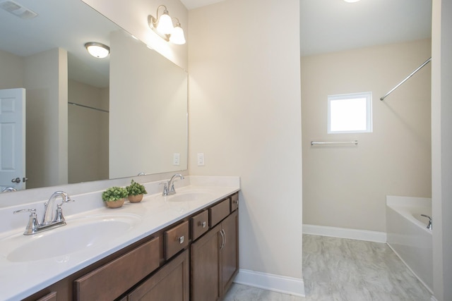 bathroom with hardwood / wood-style floors, vanity, and a tub