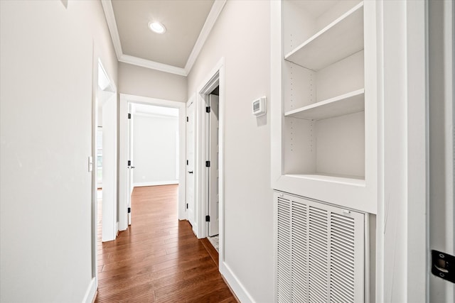 corridor with crown molding and dark wood-type flooring