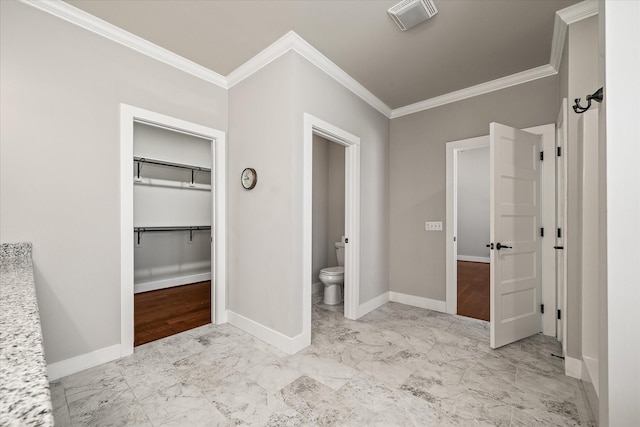 bathroom with toilet and crown molding