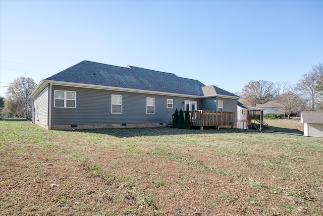 back of house featuring a yard and a wooden deck