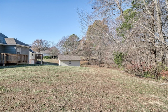 view of yard with a deck and a storage unit