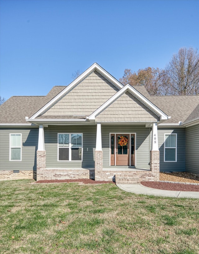 craftsman inspired home with covered porch and a front yard