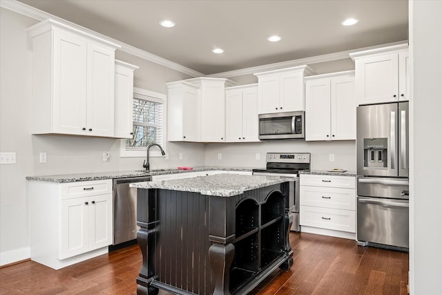 kitchen with dark hardwood / wood-style floors, a kitchen island, white cabinetry, and stainless steel appliances