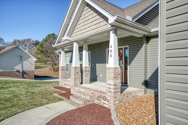 property entrance with a lawn and a porch