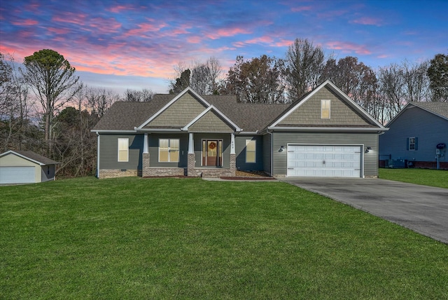 craftsman house with a lawn and a garage