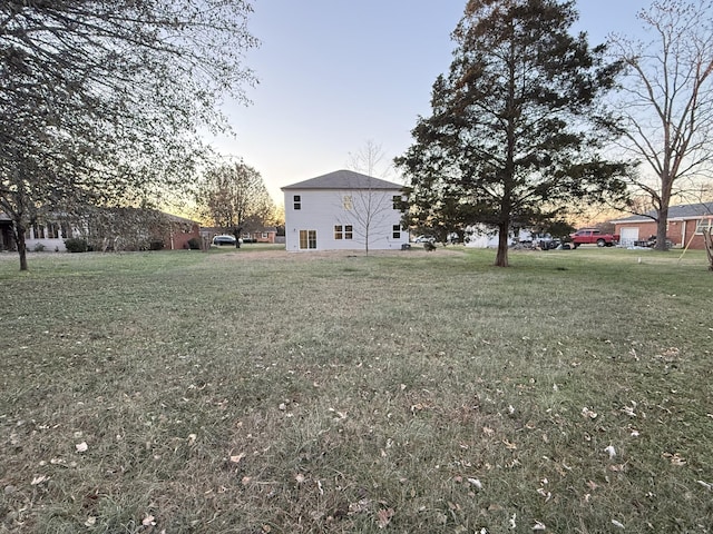 view of yard at dusk