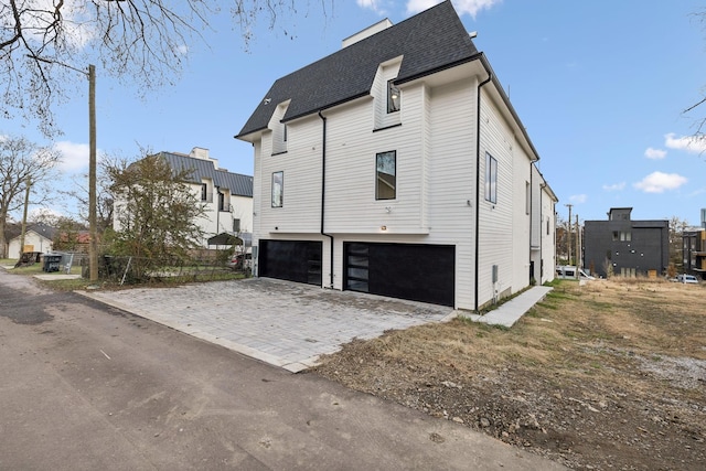 view of side of property with a garage