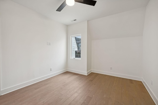 unfurnished room with ceiling fan, hardwood / wood-style floors, and lofted ceiling