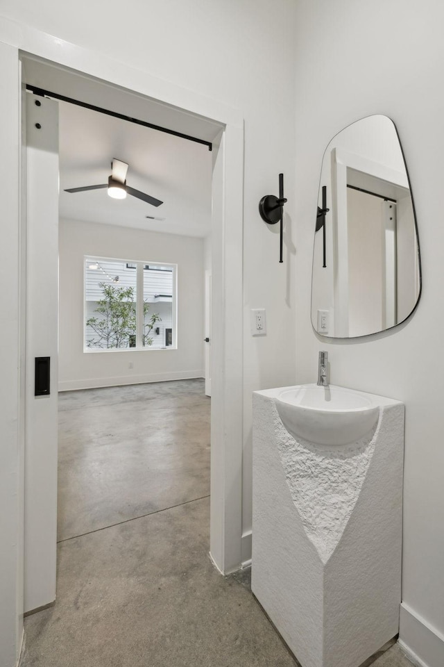 bathroom with ceiling fan, vanity, and concrete floors