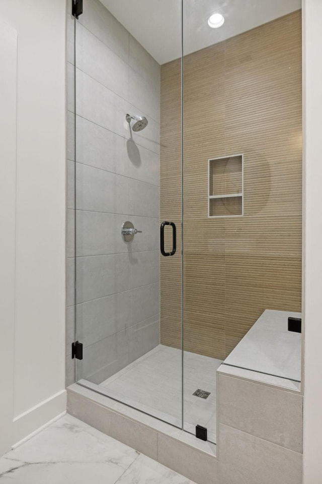 bathroom featuring a shower with shower door