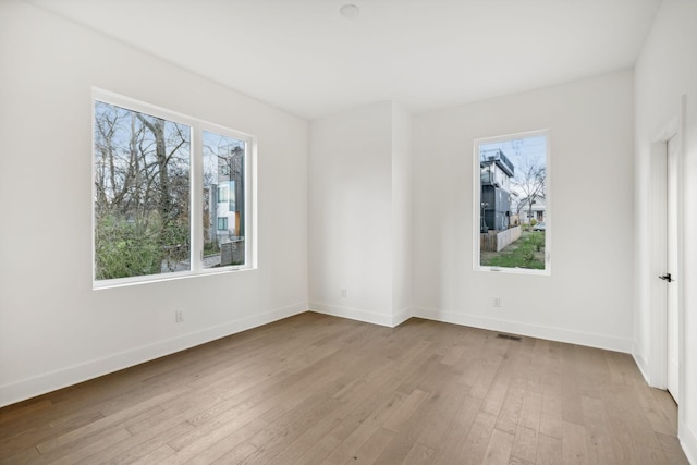 unfurnished room with light hardwood / wood-style floors