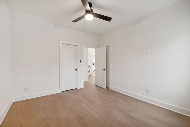 unfurnished room with ceiling fan and light wood-type flooring