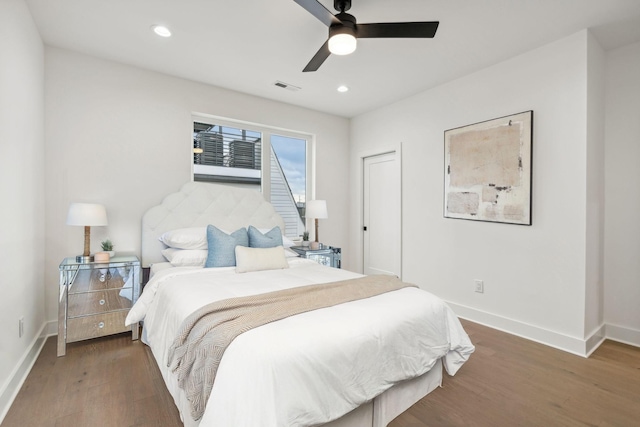 bedroom with ceiling fan and dark hardwood / wood-style floors