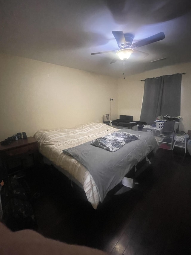 bedroom with ceiling fan and hardwood / wood-style flooring