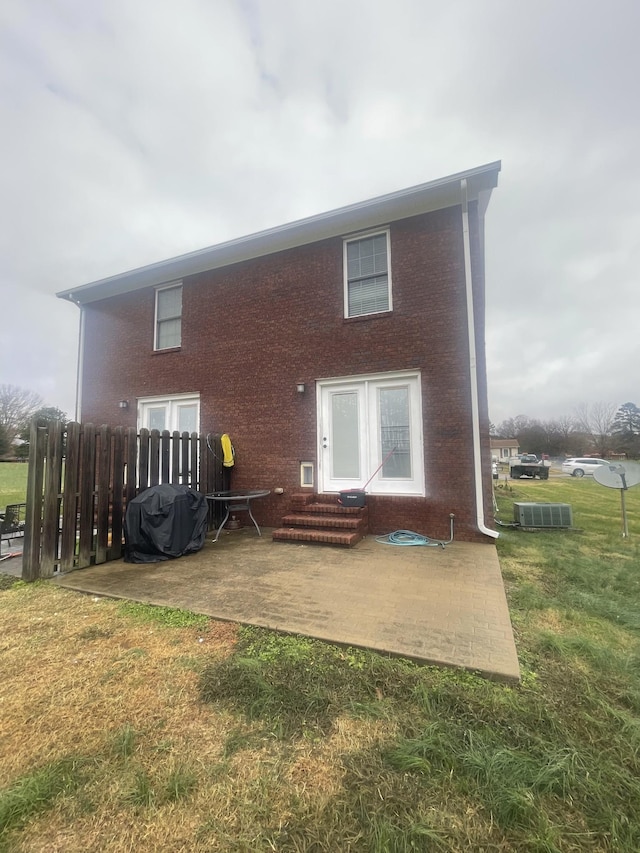 rear view of house with a lawn and a patio area