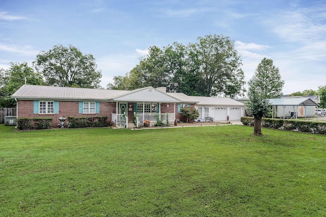 ranch-style house featuring a front yard, a porch, and a garage