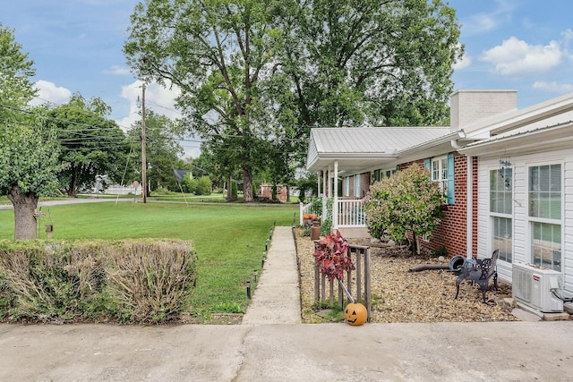 view of yard featuring ac unit and covered porch