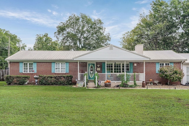 ranch-style home with covered porch and a front yard