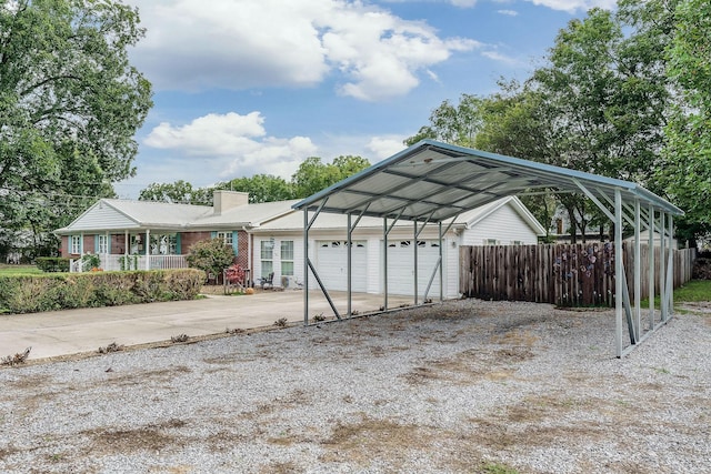 view of parking / parking lot featuring a carport and a garage