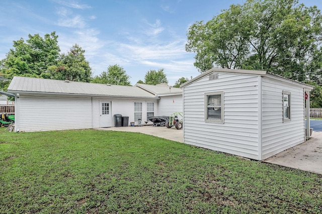 back of property featuring a lawn and a patio area