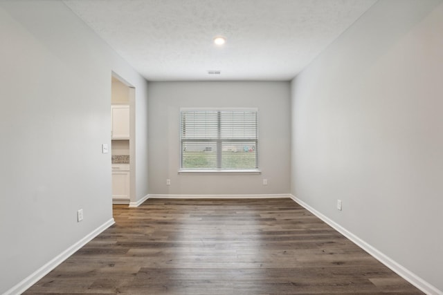 empty room with dark hardwood / wood-style floors