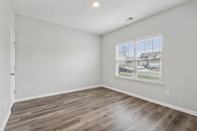 spare room with dark hardwood / wood-style floors