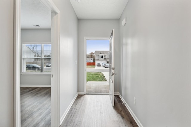 doorway to outside with hardwood / wood-style floors and a healthy amount of sunlight