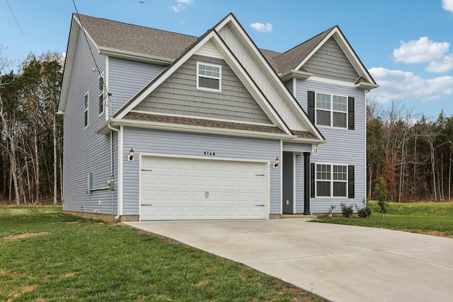 craftsman house with a front yard and a garage