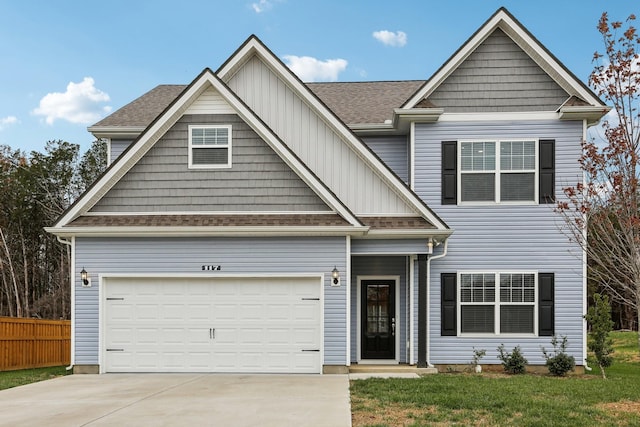 craftsman inspired home featuring a garage and a front lawn