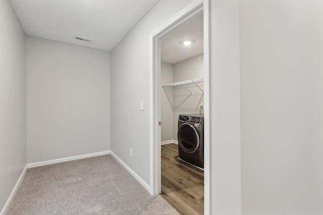 laundry area with carpet and washer / dryer