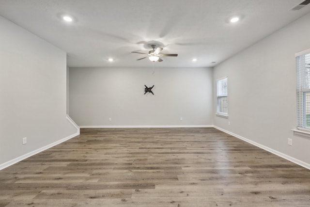 unfurnished room featuring hardwood / wood-style flooring, plenty of natural light, and ceiling fan