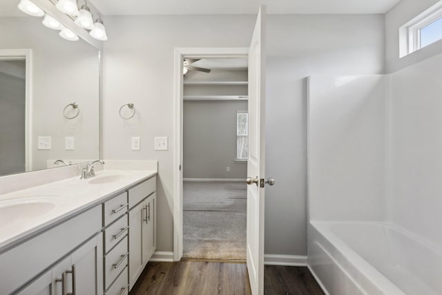 bathroom with shower / bathing tub combination, ceiling fan, vanity, and hardwood / wood-style flooring